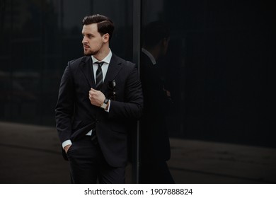 Fashionable man wearing classy suits in the city surrounding - Shutterstock ID 1907888824