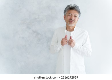 Fashionable Middle Aged Asian Man Dressing Up White Shirt