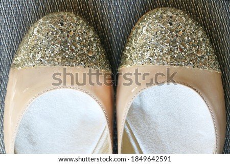 Fashionable modern flat leather shoes with gold glitter sparkling toes