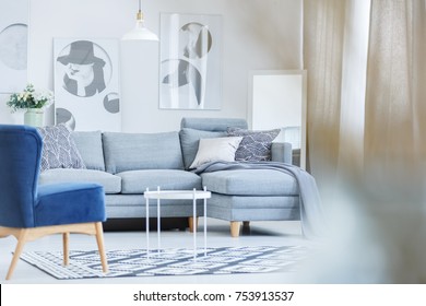 Fashionable Monochromatic Room With Blue Vintage Chair And Mirror