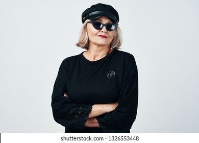 Fashionable Older Woman Wearing Dark Glasses And A Hat On Her Head                        