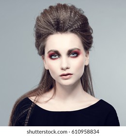 Fashionable photo. Beautiful young woman in a stylish hair and bright makeup.