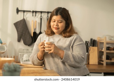 Fashionable plus size elegant woman at morning with cup of coffee. Morning concept. Life of Beautiful Young Woman xxl size. Looking at cup of coffee. - Powered by Shutterstock