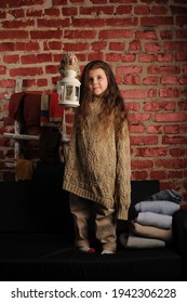 
Fashionable Portrait Of A Girl 5 Years Old In A Knitted Sweater On A Black Background