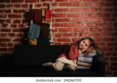 
Fashionable Portrait Of A Girl 5 Years Old In A Knitted Sweater On A Black Background