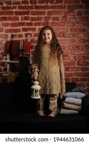 Fashionable Portrait Of A Girl 5 Years Old In A Knitted Sweater On A Black Background