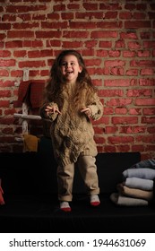 Fashionable Portrait Of A Girl 5 Years Old In A Knitted Sweater On A Black Background