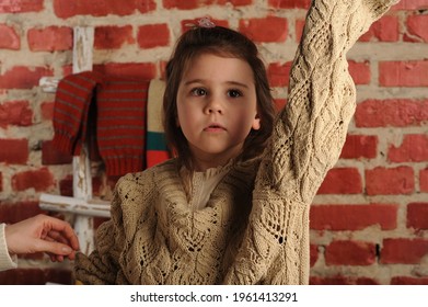 
Fashionable Portrait Of A Girl 5 Years Old In A Knitted Sweater On A Black Background