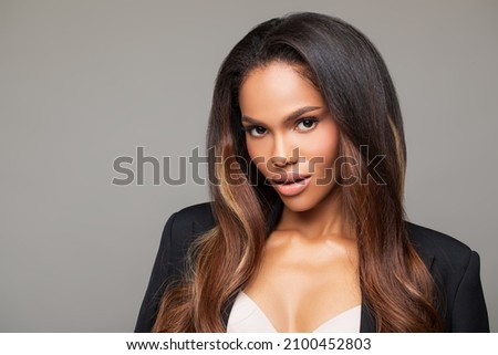 Fashionable Portrait girl in  light background. Portrait of beautiful black woman. Makeup. Close-up Fashion Portrait black woman on gray  background       