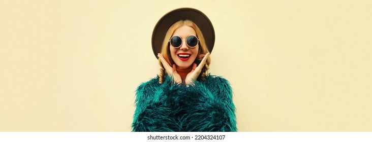 Fashionable Portrait Of Stylish Excited Woman, Surprised Female Model Wearing Blue Faux Fur, Round Hat On White Background