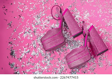 Fashionable punk square toe ankle strap pumps and confetti on pink background, flat lay with space for text. Shiny party platform high heeled shoes