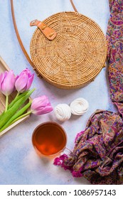 Fashionable Rattan Bag, Cup Of Tea, Tulips And Scarf On Light Background. Copy Space, Top View