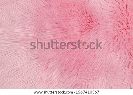 Fashionable rose pink color fur texture. Pink fluffy fur, fashion background. Decorative soft pink dyed sheepskin.