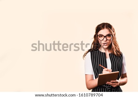 fashionable smiling woman. Business woman brunette in glasses. With folder and notebook for writing. business style.Business concept.