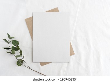 Fashionable Stock Stationery Background - White Card For Lettering And Sprigs Of Eucalyptus On A White Table. Wedding Feminine Background.