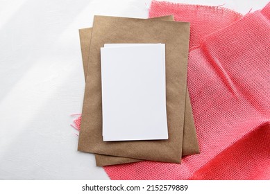 Fashionable Stock White Background And Blank Postcard Blank On A Linen Napkin