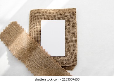 Fashionable Stock White Background And Blank Postcard Blank On A Linen Napkin