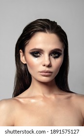 Fashionable And Stylish Brunette Girl With Wet Hair And Bright Eye Makeup. Smokey Eyes. Beauty Photo