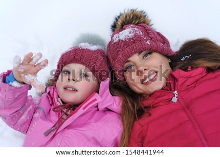 Fashionable stylish family having fun playing in snow. Weekends activities outdoor in cold weather. Winter fun family. Happiness to be parent. Family look. Lifestyle concept. Atmospheric moment.
