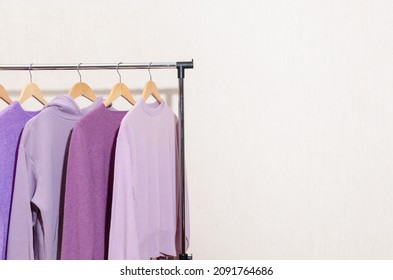 Fashionable Tops In Trendy Purple, Very Peri, Lavender Colors Hanging On A Shopping Rail. Styling, Circular Economy.