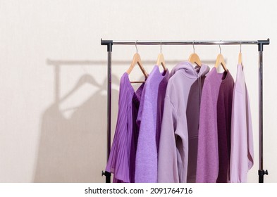 Fashionable Tops In Trendy Purple, Very Peri, Lavender Colors Hanging On A Shopping Rail. Styling, Circular Economy.