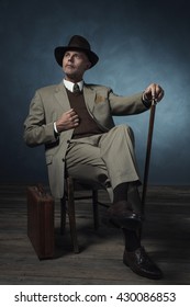 Fashionable Vintage 1940 Business Man With Cane Sitting On Chair In Room.