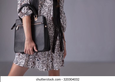 Fashionable Woman With Black Leather Bag