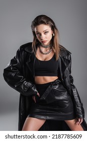 Fashionable Woman In Black Leather Outfit Posing With Hand On Hip Isolated On Grey