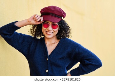 Fashionable woman with curly hair, hat and sunglasses posing - Shutterstock ID 2278101825