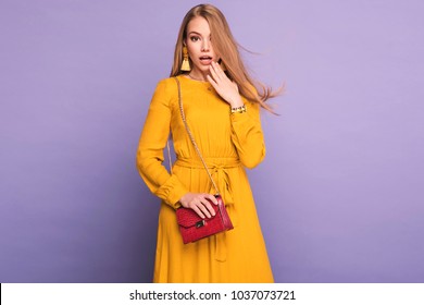 Femme à la mode en jolie robe jaune, sac à main et accessoires. Mode printemps