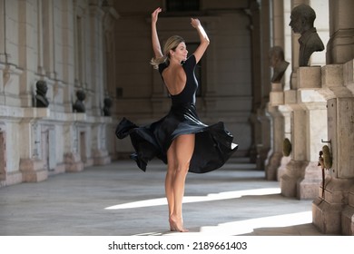 Fashionable Woman On The Street, Fashion Street Style. Sexy Movement In Skirt. Sensual Woman Dancing Outside, Ballerina Dance In Black Dress.