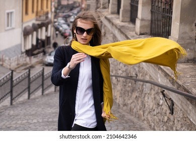 Fashionable Woman With Scarf Blowing In Wind On The Street, Fashion Street Style. Windy Scarf.