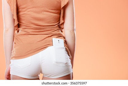 Fashionable woman with smartphone in pocket. Summer fashion. Holidays vacation.
