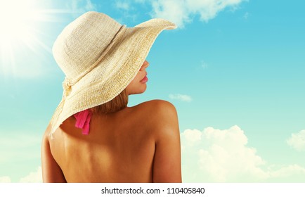 Fashionable Woman With Straw Hat Protects From Sun