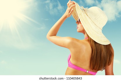 Fashionable Woman With Straw Hat Protects From Sun