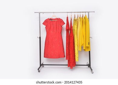Fashionable yellow, red clothes with suit winter jacket with red, yellow dress ,sundress on hanger
				
				