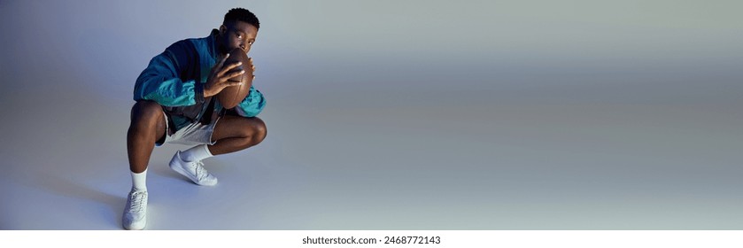 A fashionable young African American man crouching in stylish attire against a white background. - Powered by Shutterstock