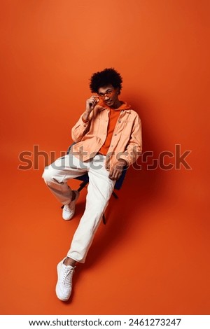 Image, Stock Photo Thoughtful young bold African American female model in trendy outfit and sunglasses looking away on pink background