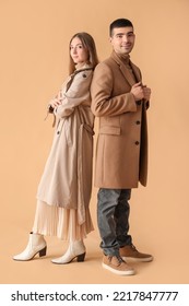 Fashionable young couple in autumn clothes on beige background - Shutterstock ID 2217847777