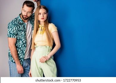 Fashionable Young Couple Posing In Summer Clothes On Grey And Blue