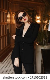 Fashionable Young Model Woman In An Elegant Black Suit And Black Sunglasses. Beauty, Fashion. Optics And Eyewear