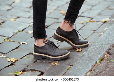 Fashionable Young Woman In Black Jeans And Boots On The City Streets. Fashion. Stylish .