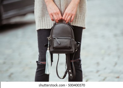 Fashionable Young Woman In Black Jeans,beige Cardigan And Bagpack On The City Streets. Fashion. Stylish .