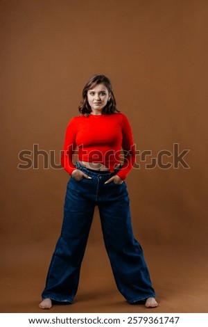 Similar – Image, Stock Photo Portrait of young bold African American female in long zipper coat confidently looking at camera standing on orange background