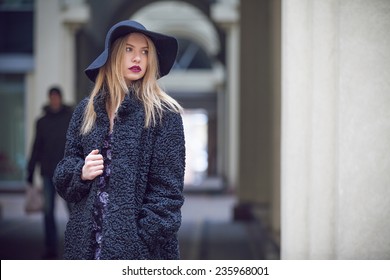 Fashionable Young Woman Posing Outside In A City Street. Winter Fashion