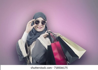 Fashionista Arabic Girl Posing, Wearing Abaya, Hijab And Sunglasses, Holding Shopping Bags