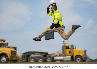 Fast building. Funny construction worker jumping. Excited jump of builders run in helmet. Worker in hardhat. Construction engineer in builder uniform run and jump. Excited foreman.