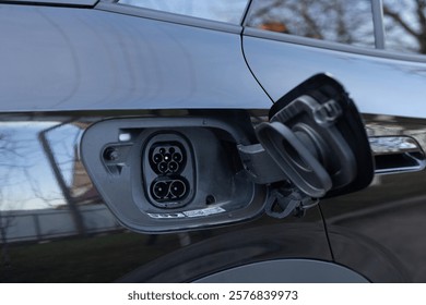 Fast charging socket type 2 combo electric car. Type 2 CCS plug port on electric vehicle. DC - CCS type 2 EV charging connector at EV car. Eco friendly alternative energy green environment concept