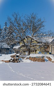 A fast, cold river flows through a winter landscape on a bright, sunny day. Snow blankets the ground, covering nearby trees, small houses, and quiet roads that wind through the scene. The dark, moving water contrasts beautifully with the white surroundings, while sunlight reflects off icy edges and shimmering ripples. Tall trees along the riverbanks are heavy with snow, adding depth and texture to the composition.

In the distance, simple houses sit peacefully among the trees, their roofs covered in white, suggesting warmth and shelter within the cold season. Snow-covered roads lead through the landscape, guiding the eye and adding a sense of place and direction. The air feels crisp and fresh, enhancing the clean, calm atmosphere.

This winter scene combines natural energy with human presence, making it ideal for themes such as seasonal travel, rural life, winter lifestyle, resilience, and European countryside beauty.