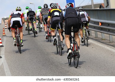 Fast Cyclists During The Race On Uphill City Roads